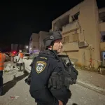 Two injured in building hit; weapons seized